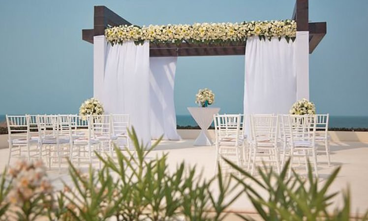 Secrets Playa Mujeres Weddings_Ocean Front Ceremony arch draping decorations